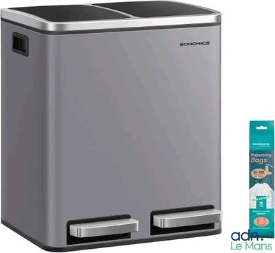 a silver trash can with a toothbrush and toothpaste next to it