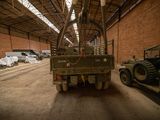 a military truck that is parked in a building
