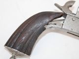 a gun with a wooden handle on a white surface