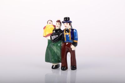 a figurine of a man and a woman holding a book