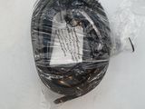 a plastic bag on the ground with a piece of equipment in it