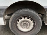 a white van with a flat tire parked on the street