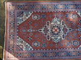 rug laying on the ground with a cat laying on top of it