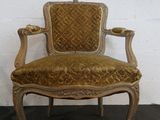 an old fashioned chair with a gold upholstered seat