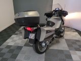 a motorcycle that is parked in a room with a checkered floor