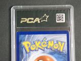a pokemon card in a plastic case on a table