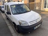 a white van that is parked on the side of the street