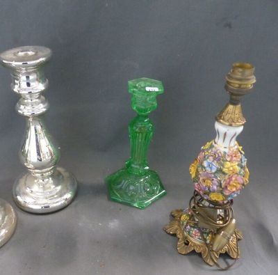 several different colored glass candlesticks sitting next to each other on a table
