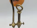 a lamp that is sitting on a stand with a cord