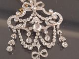 a close up of a diamond and gold necklace on a black surface
