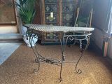 a table with a marble top in the middle of a room