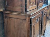a large wooden cabinet with carvings on it in a room