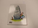 the book is sitting on a table with a picture of a rock