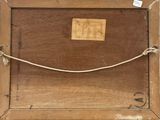 an old wooden box with a rope and a tag on it