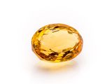 a yellow sapphire stone on a white background