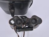 a black pot with a pair of binoculars on top of it