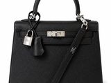 a black leather handbag with a lock on the handle
