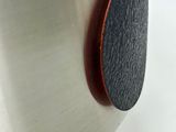 a close up of a stainless steel pot with a wooden lid