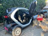 a small car that is parked on the side of the road