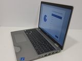 a laptop computer sitting on a table with a mouse on it