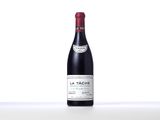 a bottle of red wine sitting on top of a table