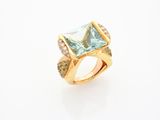 a gold ring with a blue topaz stone surrounded by diamonds