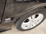 a close up of a car ' s door handle and tire