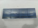 three boxes of perfume sitting on top of a white table