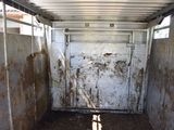 an image of a dirty horse trailer with dirt on the floor