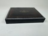 an antique black leather box with a decorative design on the lid