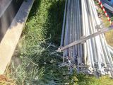 a pile of metal pipes sitting on the side of the road