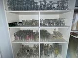 many glasses and bottles on the shelves in the room