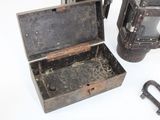 a small metal box with a key inside of it