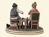 a figurine of two people sitting at a table