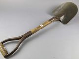 a shovel with a wooden handle on a white surface