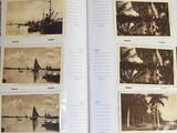 an open book with pictures of boats on the water and palm trees