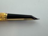 a pen that is sitting on a white surface