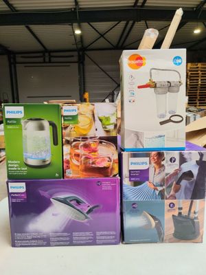 several boxes of household items are stacked on a table in a warehouse