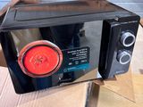 a microwave sitting on top of a box on a table