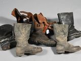 de nombreuses paires de bottes alignées par terre