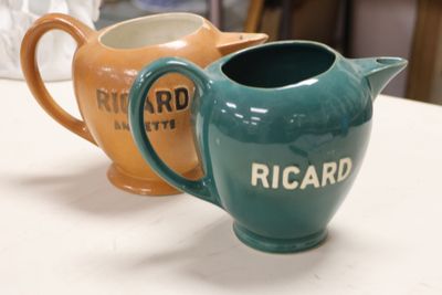 two pitchers that are sitting on a table