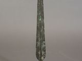 an image of a small bronze sword on a black stand