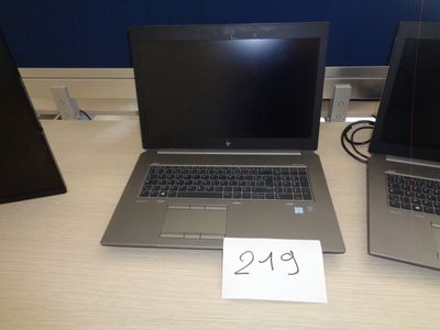 two laptops sitting on a table with a price tag on it