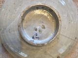 a close up of a white plate with a blue writing on it