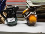 two vases that are sitting on a shelf