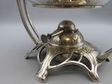 an antique silver plated bowl on a stand with a bird on it
