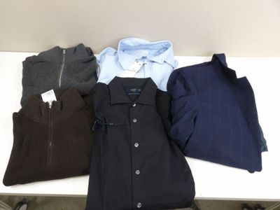 three men ' s shirts are lined up on a white table