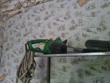a picture of a chainsaw on a shelf in the corner of a room