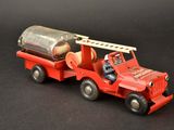 a red toy truck with a barrel on the back of it