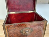 a wooden chest with a metal handle on a wooden floor
